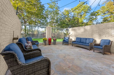 Outdoor seating area with lush greenery
