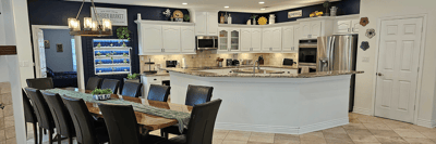 Spacious kitchen and dining area in assisted living facility.