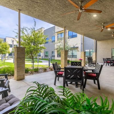 Outdoor seating area with plants and tables
