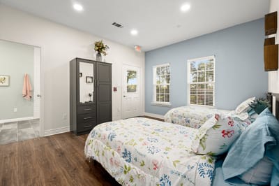 Light-filled bedroom with twin beds and decor