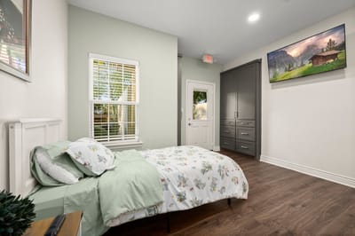 Cozy resident room with a bed and artwork