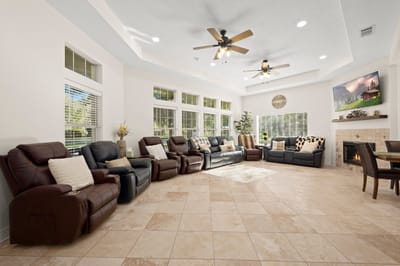 Cozy common area with reclining chairs and natural light