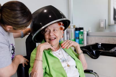 Resident enjoying a salon treatment with staff