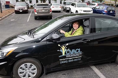 Resident enjoying a ride in a facility vehicle.