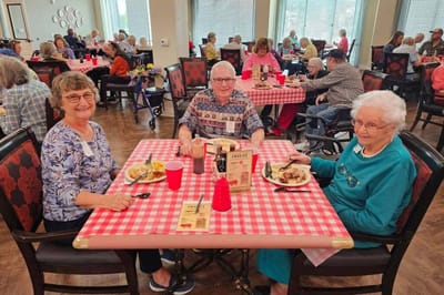 Residents enjoying a meal together in the dining room.