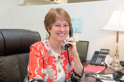 Staff member speaking on the phone in an office