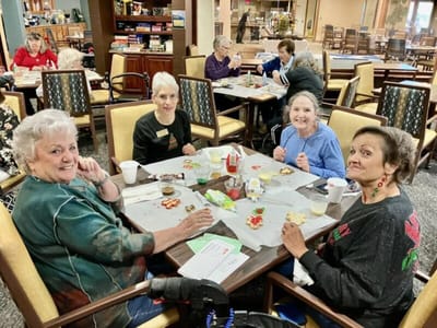 Residents enjoying a meal together in a dining area.