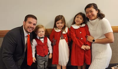 A family dressed in festive outfits