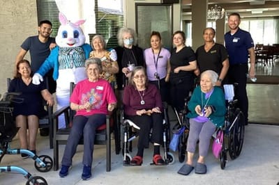 Residents and staff celebrate with a costumed bunny.