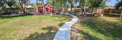 Pathway leading to a red building in a garden