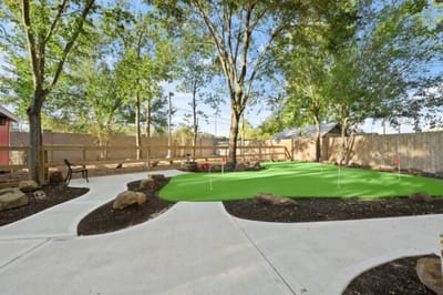 Well-maintained outdoor green space with putting greens.