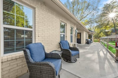 Outdoor seating area with rocking chairs.