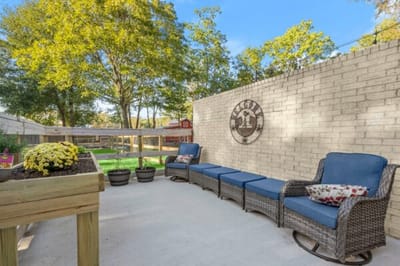 Outdoor seating area with flowers and trees