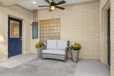Cozy outdoor seating area with flowers.