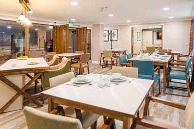 Dining area with tables set for meals.