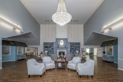Spacious common area with a chandelier and seating