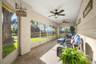 Sunlit porch area with comfortable seating