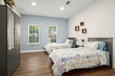 Bright and cozy resident bedroom with beds.