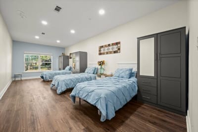 A cozy shared bedroom with two beds and decor.