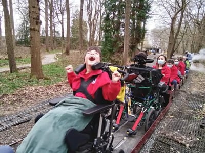 Residents enjoying a ride on a train in a park