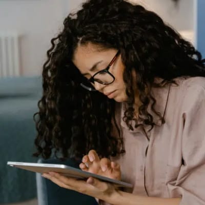 Person using a tablet in a serene setting.