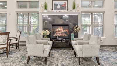 Cozy common area with chairs and a fireplace