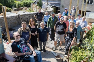 Residents and staff engaged in gardening activities.