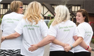 Residents wearing matching t-shirts in a garden setting