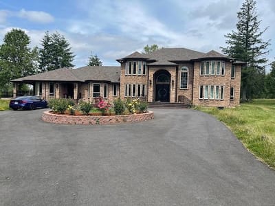 Exterior view of a large brick building with landscaping.