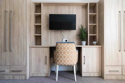 Cozy resident room with desk and chair.