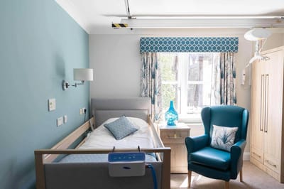 Cozy resident room with a bed and chair