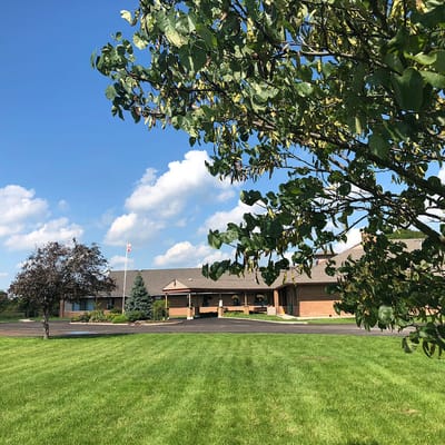 Exterior view of James Beattie House with trees.