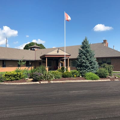 Building exterior with landscaping and flag