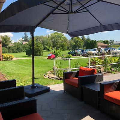 Outdoor seating area with a view of green space.