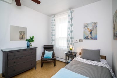 Cozy resident room with a bed and artwork