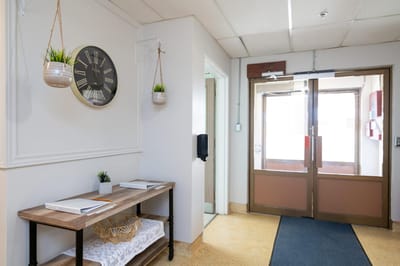 Welcoming reception area with clock and plants