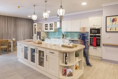 Bright kitchen area with staff member