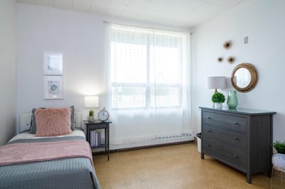 Cozy resident bedroom with natural light.