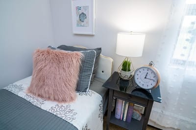 Cozy bedroom setting with bedside table and clock