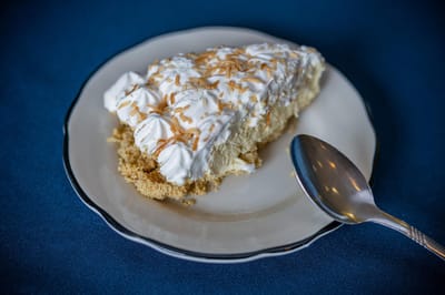 Slice of coconut cream pie on a plate