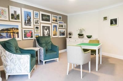 Cozy common area with chairs and decorative wall art.