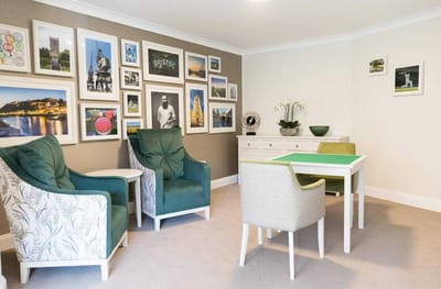 Common area with seating and framed photographs