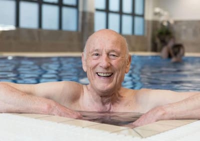 Smiling senior man enjoying a spa pool.