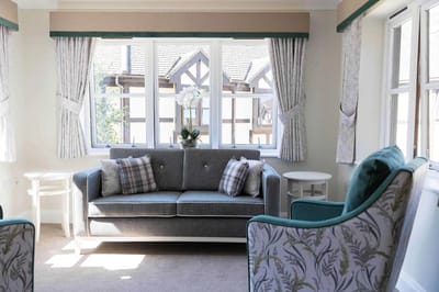Cozy living room with a couch and decorative curtains.