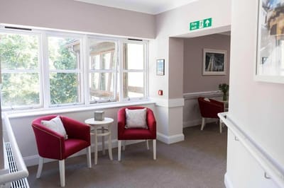 Cozy interior seating area with red chairs.