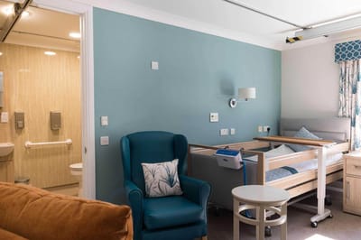 Cozy resident room with a bed and seating area.