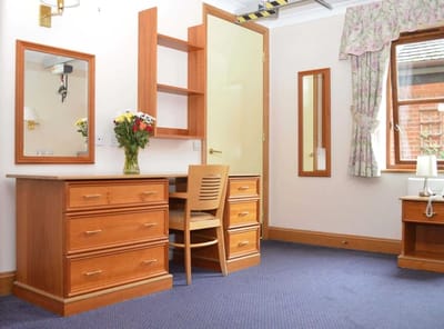 Well-furnished room with storage and a desk.