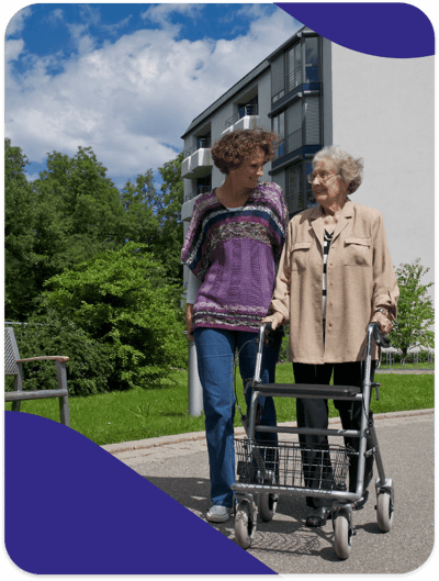 A caregiver assisting a resident outdoors
