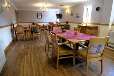Dining area with tables and chairs set up.