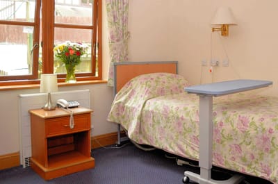 Cozy resident room with flowers and a bed